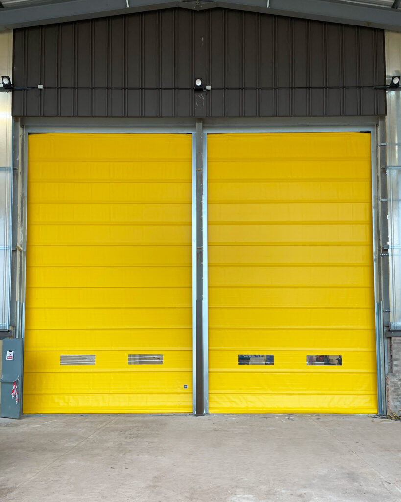 External industrial folding door with windows